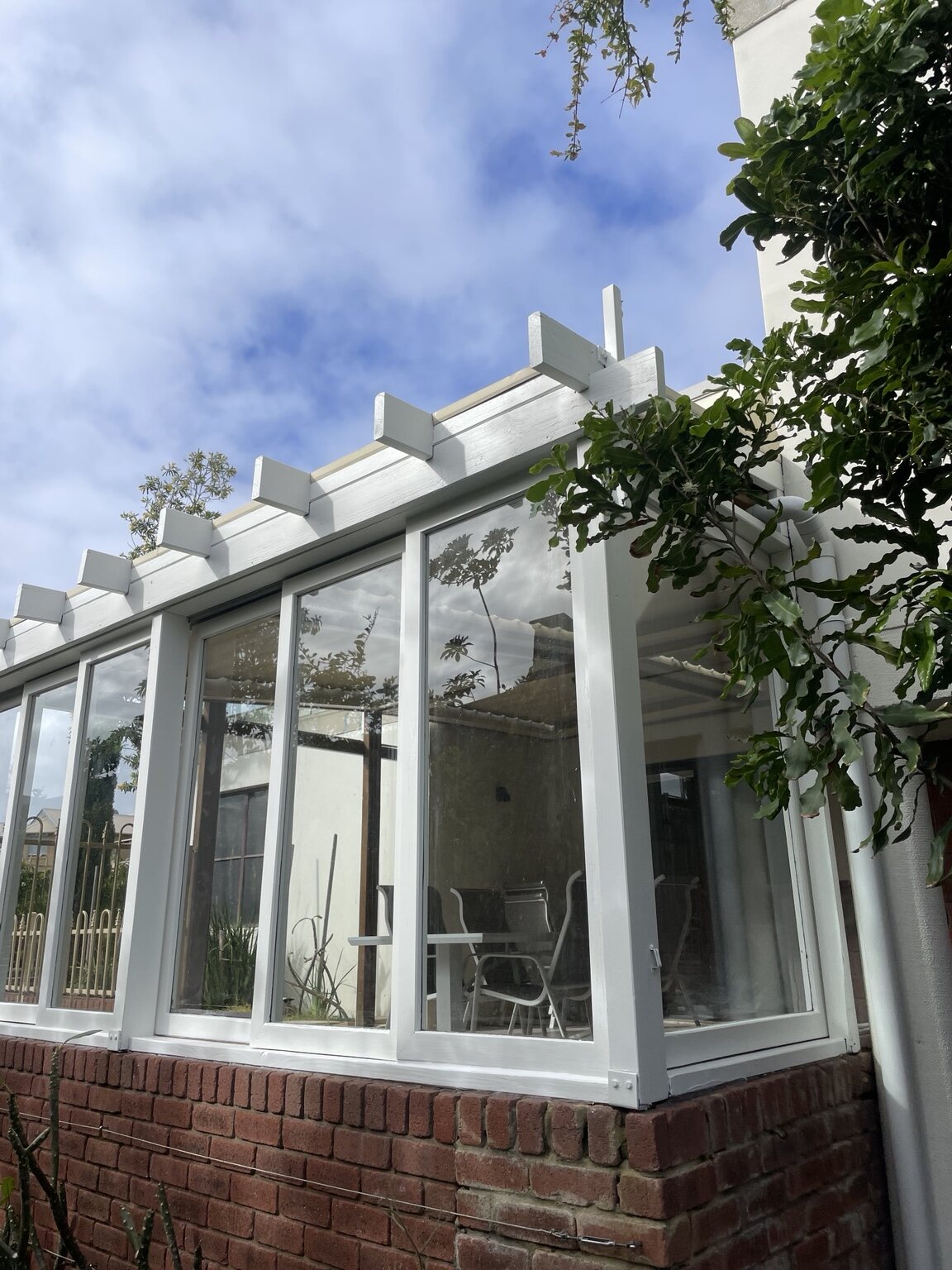 Restored exterior timber pergola and window frames