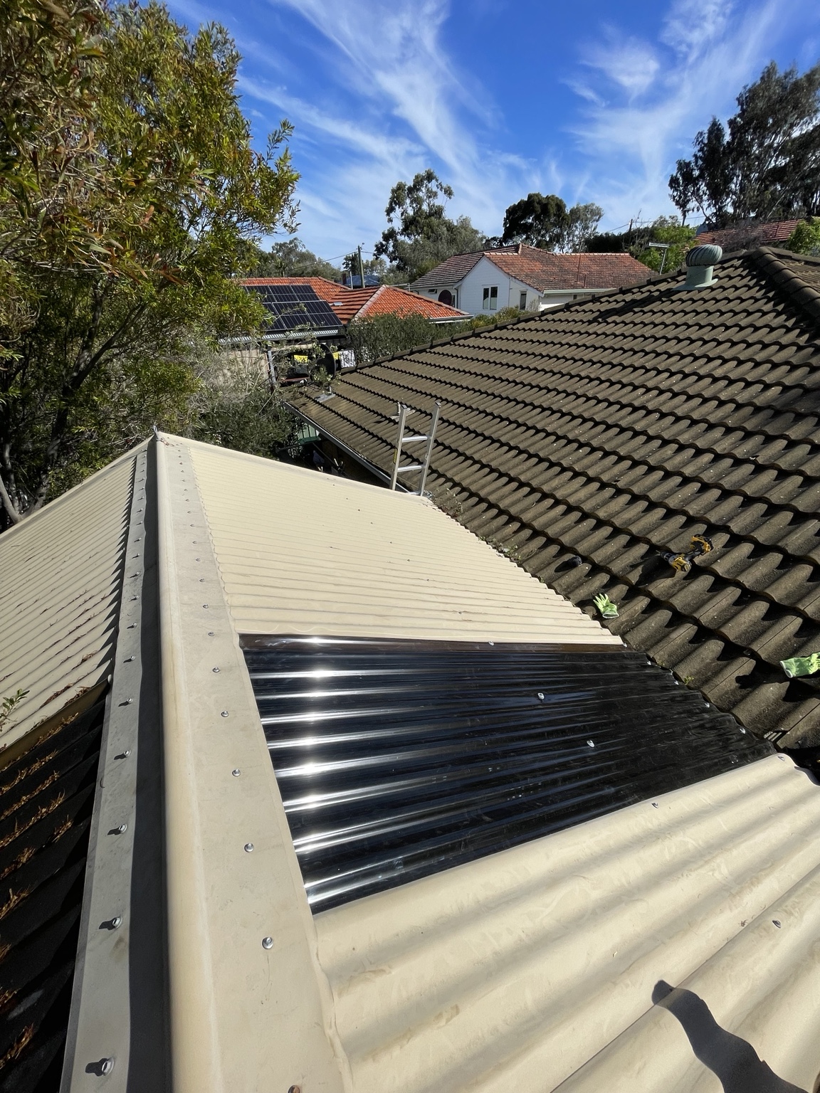 New translucent patio roof sheet fitted in place of the damaged section